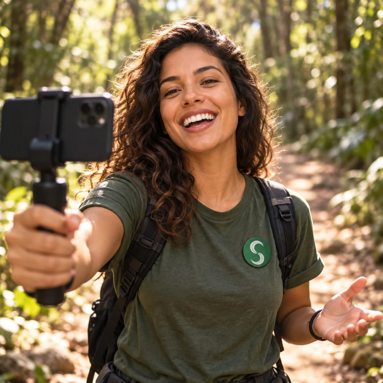 Influenciadora gravando um vídeo numa trilha, com o broche do Selo Verde